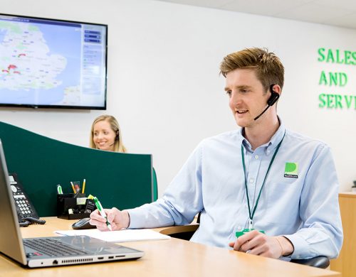Man at Desk with Headset on,