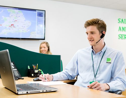 Premiere Healthcare Call operative, Sat at Desk in Call.